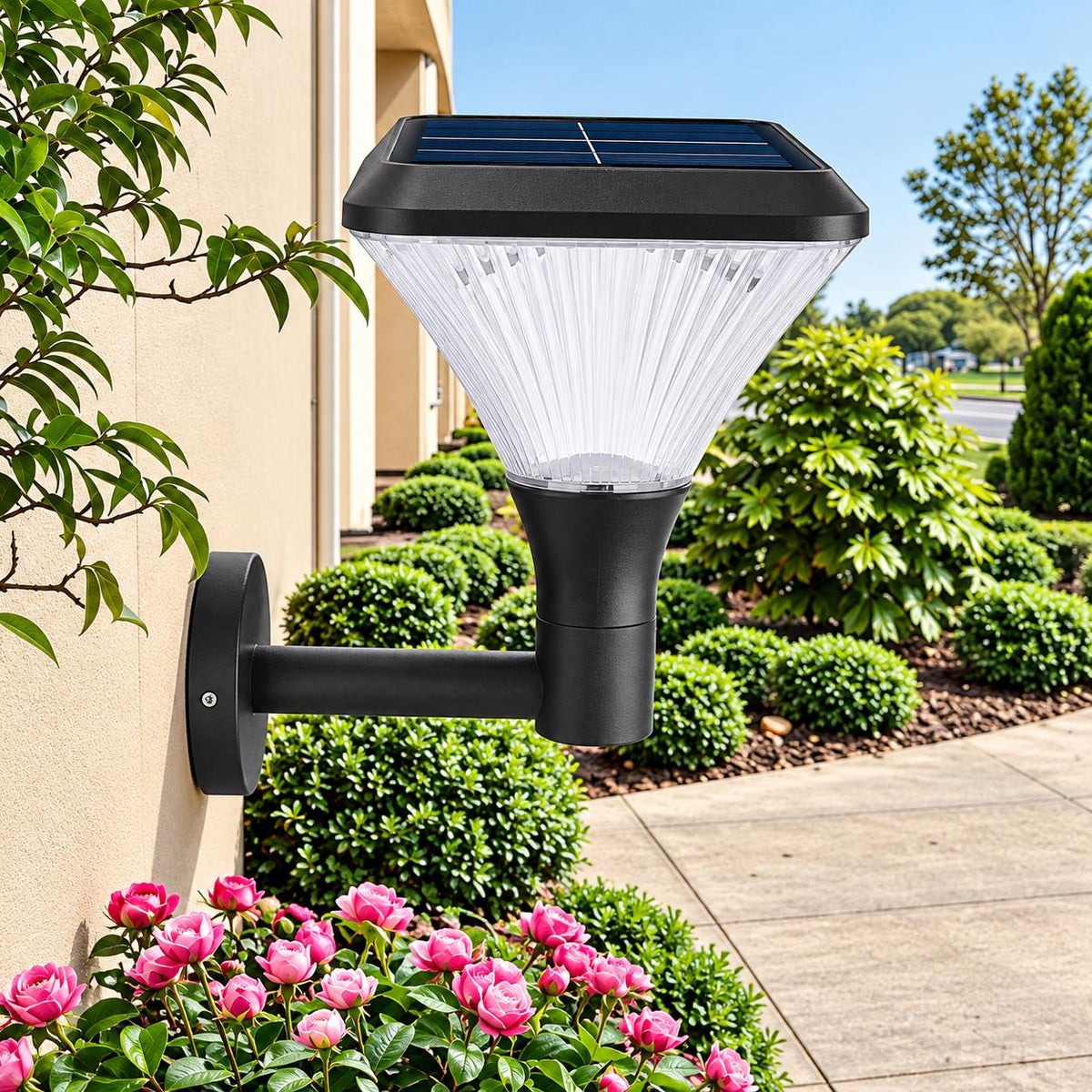 Black solar garden wall light beside a home and flowering garden